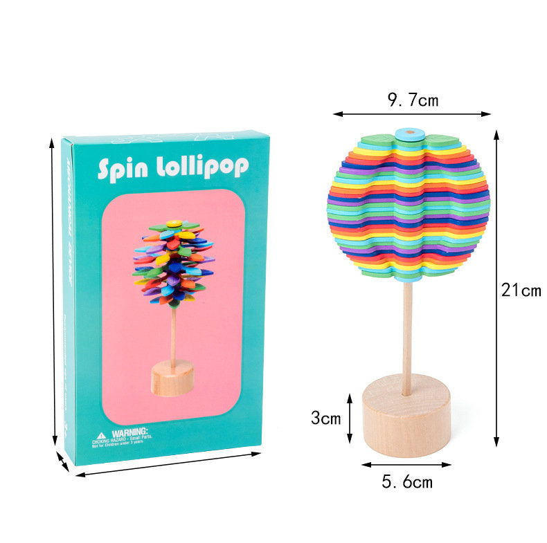 Wooden rotating lollipop toy with its box and measurements for the toy's height, width, and base