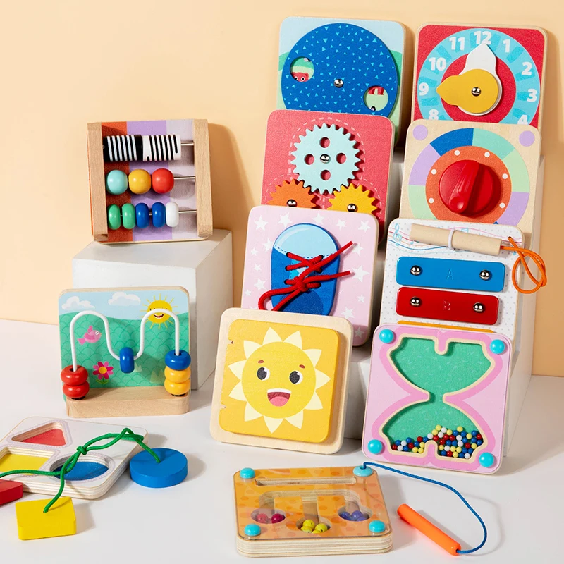 Colorful wooden magnetic busy boards with gears, a clock, laces, beads, and a shape-matching activity.