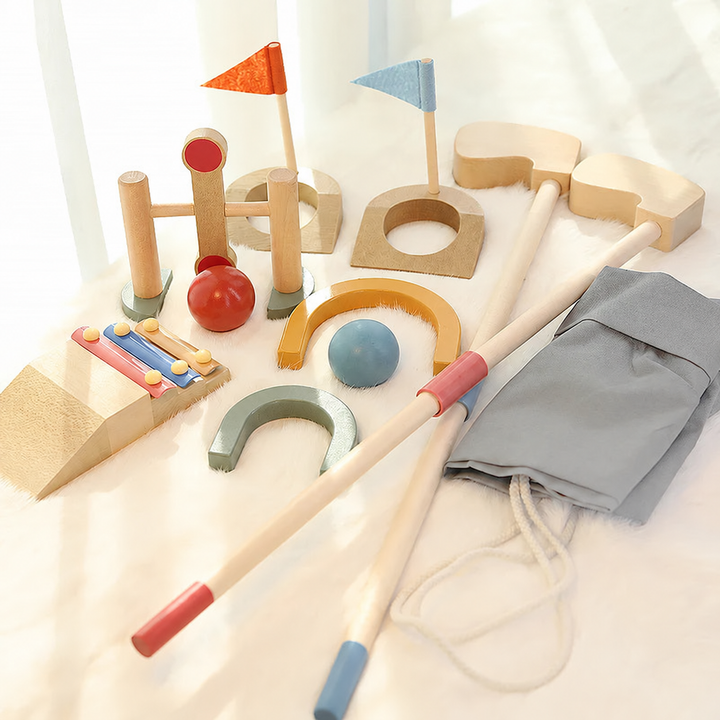 Wooden mini golf set with two clubs, red and blue balls, flag targets, obstacles and a gray drawstring bag