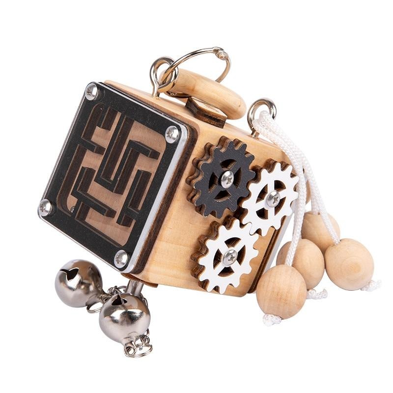 Wooden puzzle cube with a maze panel, interlocking gears, beaded cord, and bells