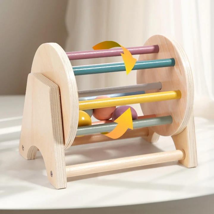 Wooden rolling drum on a stand with colored bars, inner pieces and arrows showing rotation