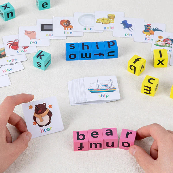 Hands matching wooden letter blocks to a bear picture card, with more word cards spread across a table