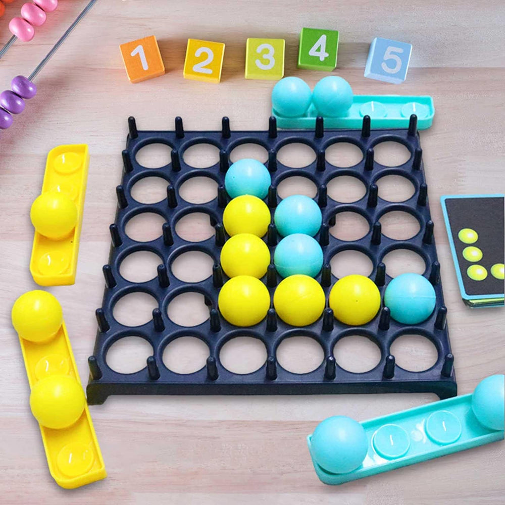 Yellow and blue balls arranged in an L-shaped pattern on the grid board beside trays and a challenge card