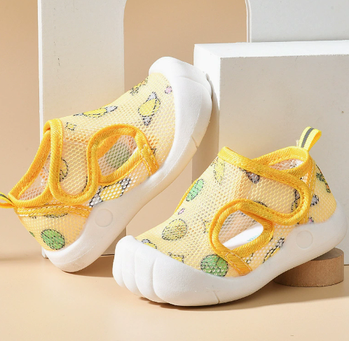 Yellow mesh sandals with citrus prints, yellow straps and white soles