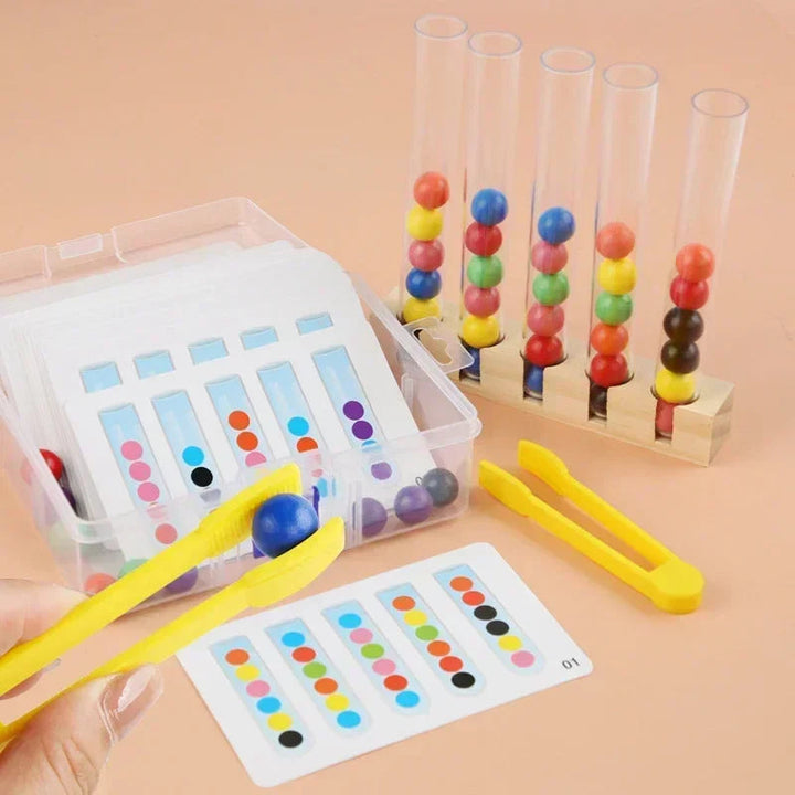 Yellow clip holding a blue ball next to a pattern card and filled sorting tubes