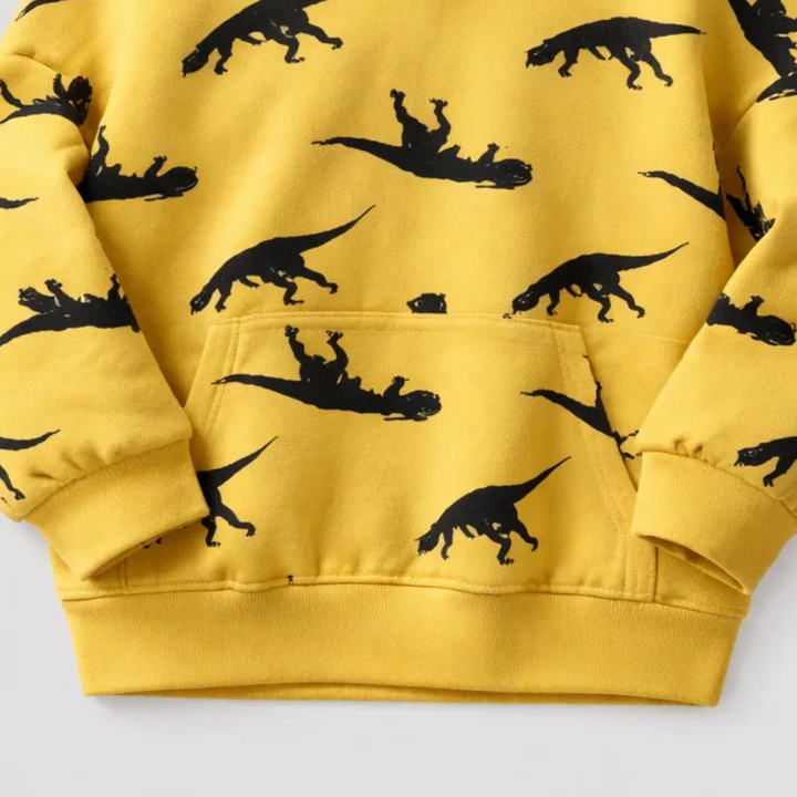 Yellow dinosaur hoodie showing the front pocket, ribbed cuffs, and ribbed hem