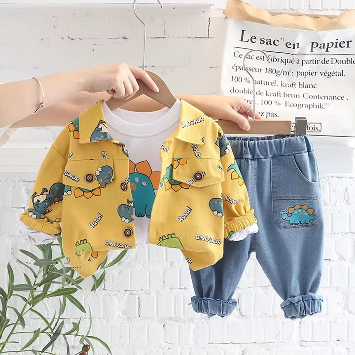 Yellow dinosaur-print jacket, white graphic T-shirt, and blue pants on wooden hangers
