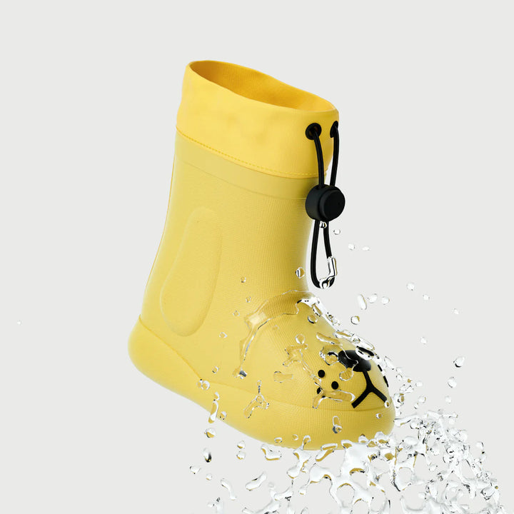 Yellow dog-face rain boot with a water splash around the toe and a drawcord cuff
