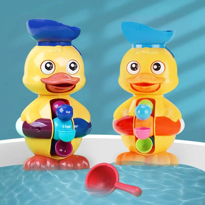Two yellow duck water-wheel bath toys beside a red scoop at the tub&