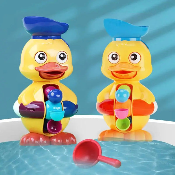 Two yellow duck water-wheel bath toys beside a red scoop at the tub&
