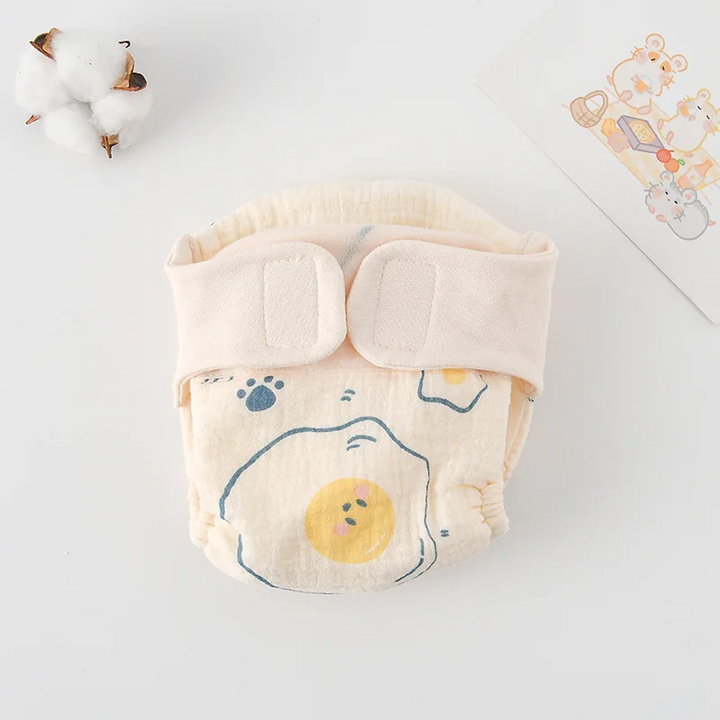 Egg-print cloth diaper with a yellow yolk illustration and cream waistband