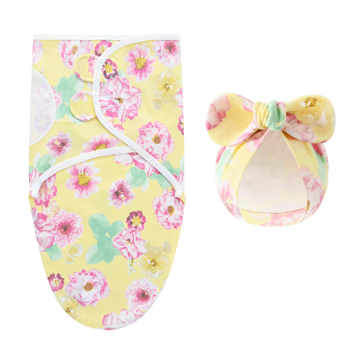 Yellow swaddle blanket and matching bow hat with pink flowers and green leaves