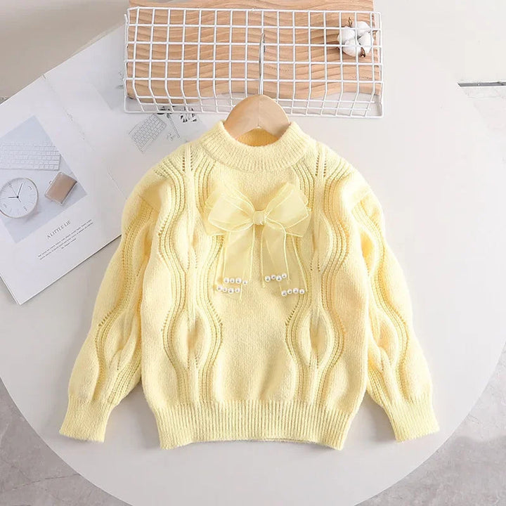 Yellow long-sleeve sweater with a sheer bow and ribbed neckline, cuffs, and hem