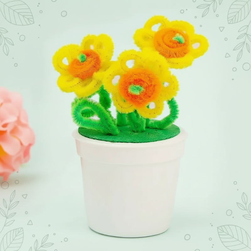Yellow loop-petal flowers with orange centers and green leaves in a white pot