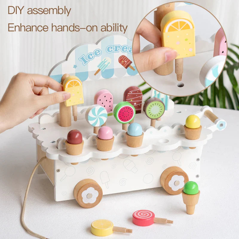 Hands placing a yellow pretend ice pop into the white cart, with a close-up of the display slot