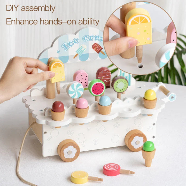 Hands placing a yellow pretend ice pop into the white cart, with a close-up of the display slot