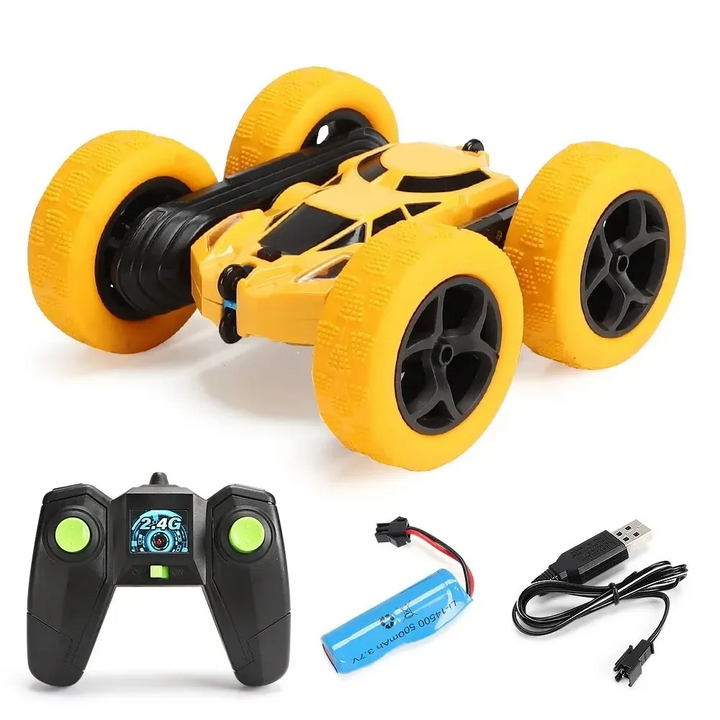 Yellow RC stunt car with wireless controller, battery, and USB charging cable