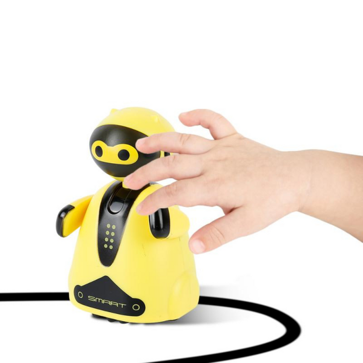 Hand placing a yellow line-following robot on a curved black line.