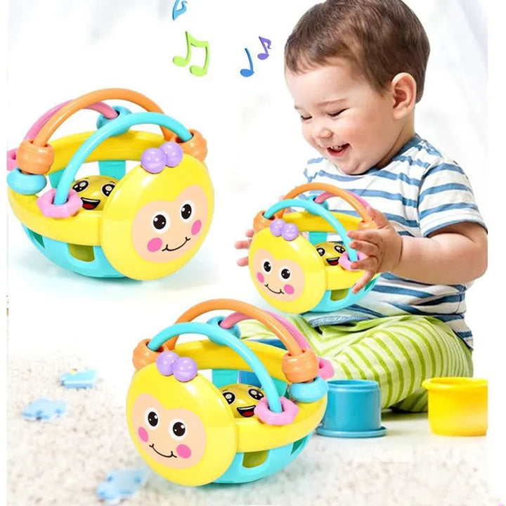 Baby playing with a yellow sensory chew toy with colorful arches and a smiling face