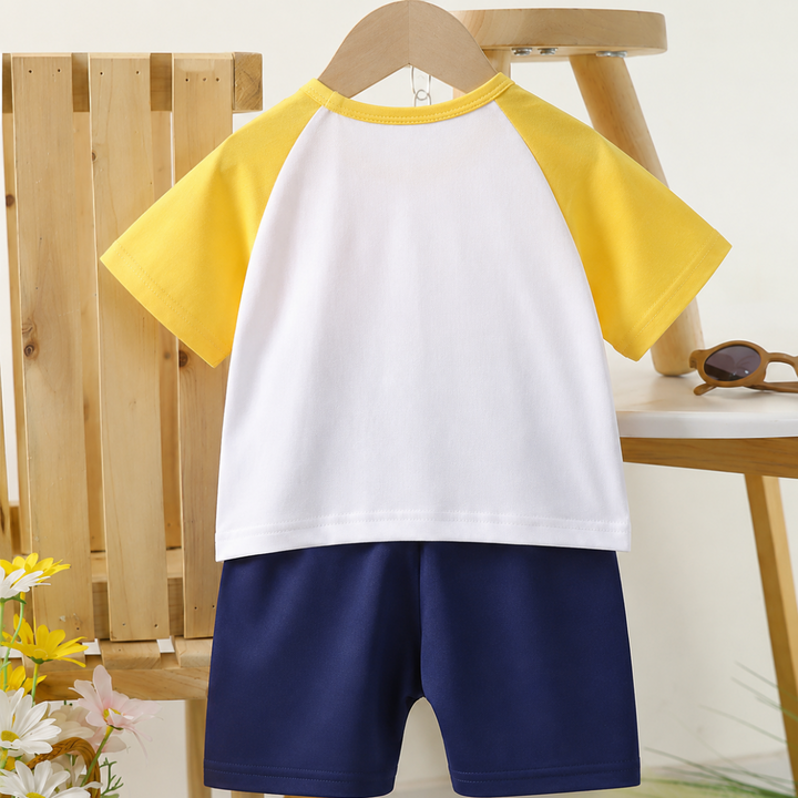 Back view of the white shirt with yellow sleeves paired with navy shorts.