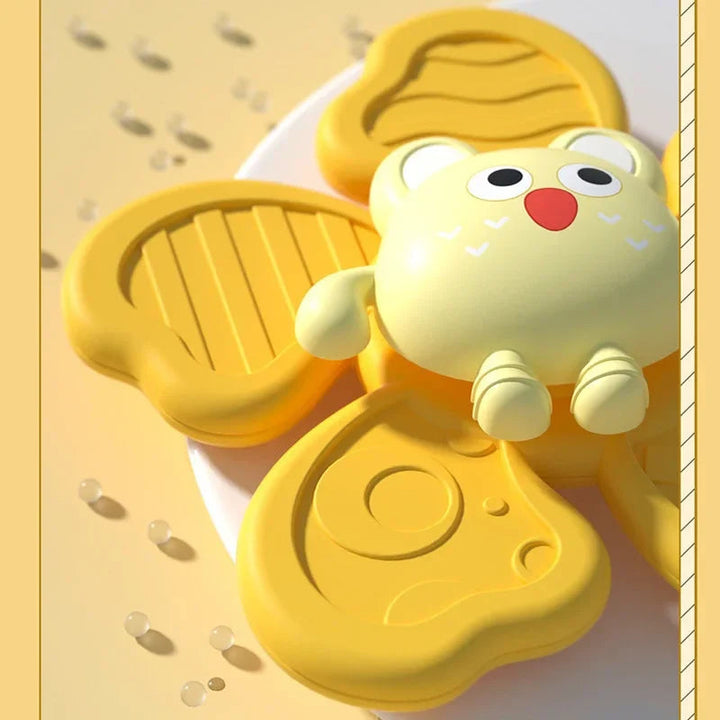 Close-up of a yellow animal spinner with raised patterns on its arms